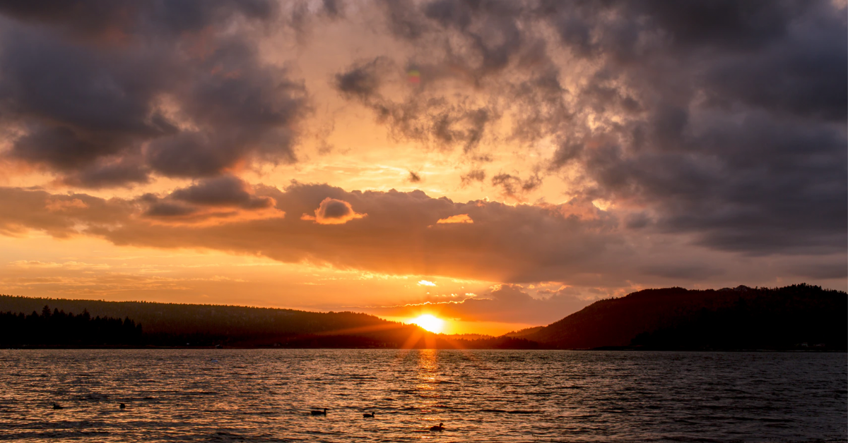 Sunset over Big Bear Lake with an overcast of clouds in the sky. 