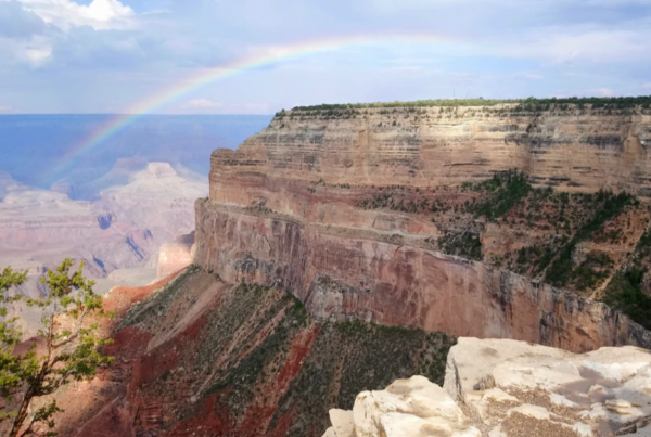 View of The Grand Canyon with a rainbow beaming on both sides.