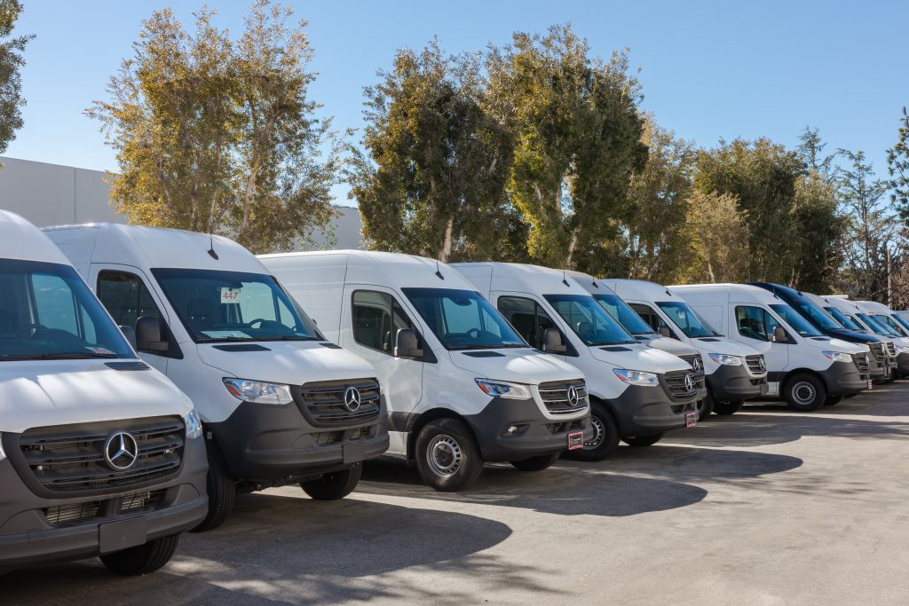 a bunch of mercedes sprinter vans lined up next to one another