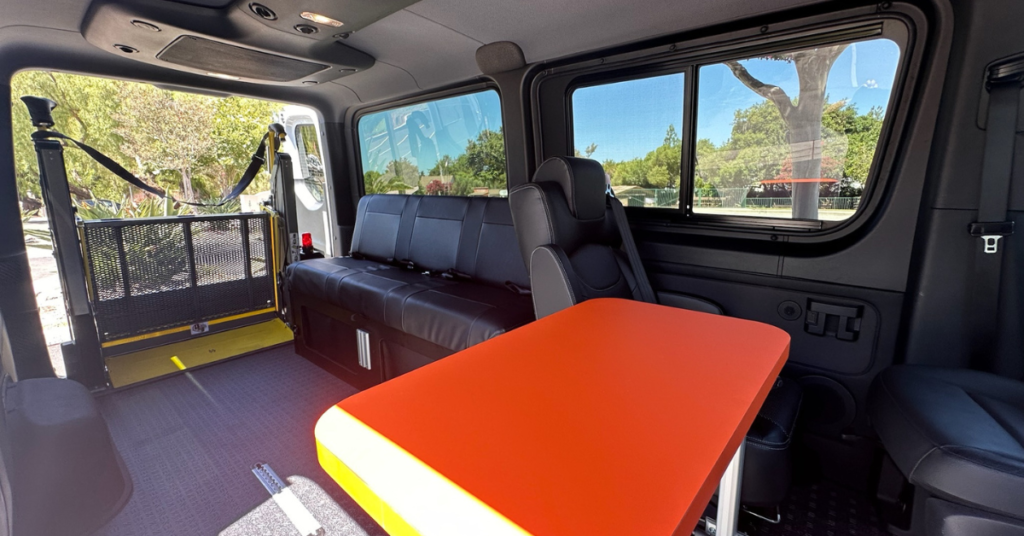 the inside of a van conversion with a lift for wheelchairs in the back