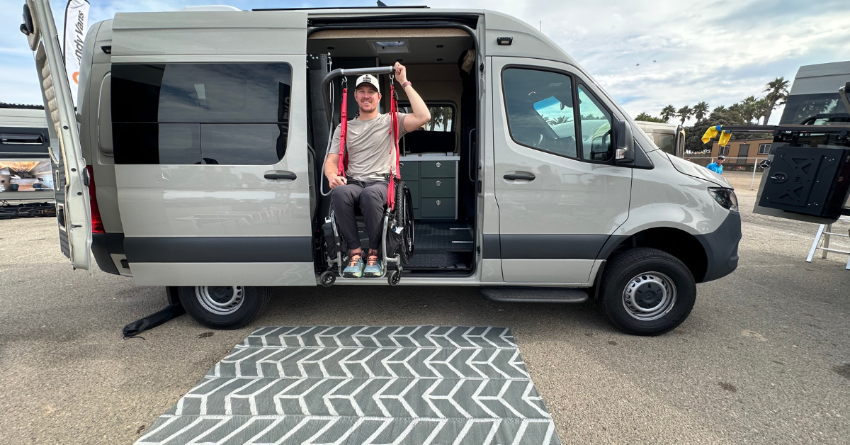 a guy in a wheel chair on a strong arm lift getting lifted into a campervan