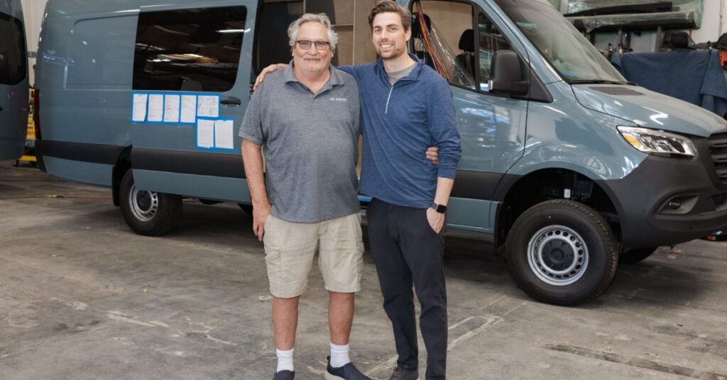 a father and son standing next to one another