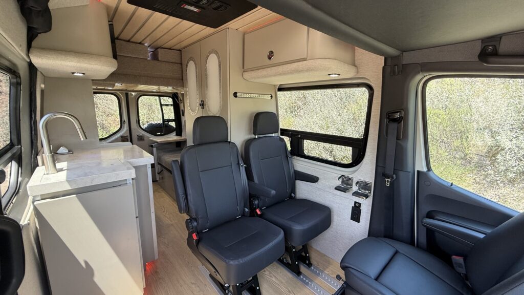 a family campervan with four seats, a bathroom / shower and a dinette with a drop down bed