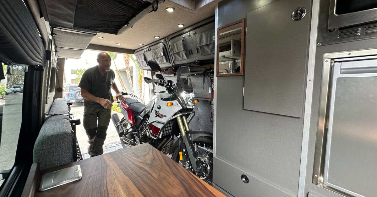 a moto campervan with a guy putting away his moto bike