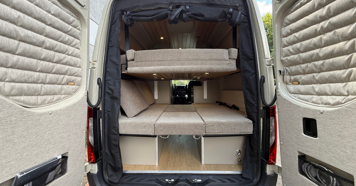 a view from the back of a sprinter campervan with bunk beds